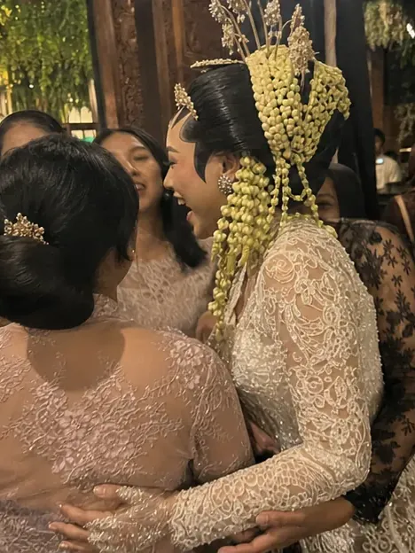 Dinda memeluk keluarga di tengah keramaian resepsi